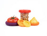 display of silicone lids hugging half of tomato, half a lemon and a small jar with walnuts