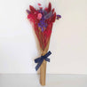 dried flowers bouquet with purple red and pink flowers with blue ribbon