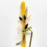 handmade beeswax stick candle for easter with dried bouquet flowers in calm colors