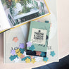 paper box with colorful papercut flowers on a table with design books