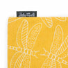 detail of  bright yellow tote bag with a design of white dragonflies and a helio feretti tag