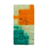 beautiful wax chocolate bar with white, orange and bluegreen pieces on a white background