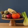 tray with vegetables on a table with a wooden brush