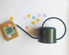 green-watering-can-with-coloured-paper-confetti-flowers
