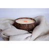 coconut shell candle on natural linen fabric