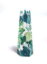 paper vase with monstera leaves on a white background
