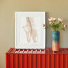 poster with two pointes with colorful sticky dots on a red metallic cupboard by a vase with pink flowers
