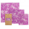 three purple bee's wrap in different sizes with the recycled paper packaging