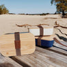 display of three eco lunchboxes with Bamboo lids on a wooden table on a sandy beach