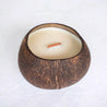 top view of a coconut shell candle on a white background