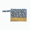 beach handbag with cork detail and leopard patterned fabric on white background
